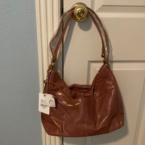 HOBO brand, Delilah, Burnished Rose in color.
